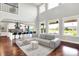 Bright open-concept living room with hardwood floors, gray sofas, and a view of the water at 2789 W High Grove Cir, Zionsville, IN 46077