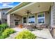 Cozy covered patio with stone fireplace, ceiling fan, and comfortable outdoor seating arrangement at 2789 W High Grove Cir, Zionsville, IN 46077