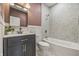 Bathroom with dark vanity, hex tile detail, and shower-tub combination at 2831 N Talbott St, Indianapolis, IN 46205