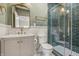 Chic bathroom with elegant vanity, gold fixtures, and a tiled shower with glass doors at 2831 N Talbott St, Indianapolis, IN 46205