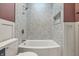 Modern bathroom featuring tub with tile surround, unique wall paint, and updated fixtures at 2831 N Talbott St, Indianapolis, IN 46205
