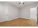 Neutral bedroom featuring hardwood flooring, ceiling fan, and white trim at 2831 N Talbott St, Indianapolis, IN 46205