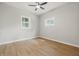 Bright bedroom featuring two windows, a ceiling fan, and modern flooring at 2831 N Talbott St, Indianapolis, IN 46205