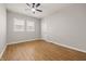 Bright and airy bedroom with wood-look flooring, ceiling fan, and plenty of natural light from two windows at 2831 N Talbott St, Indianapolis, IN 46205