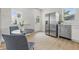 Eat-in kitchen with stainless steel appliances, white cabinets, and wood-look flooring at 2831 N Talbott St, Indianapolis, IN 46205