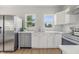 A bright kitchen boasts stainless steel appliances, white cabinets and a stylish backsplash at 2831 N Talbott St, Indianapolis, IN 46205