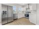Bright, modern kitchen featuring stainless steel appliances, white cabinetry, and wood-look flooring at 2831 N Talbott St, Indianapolis, IN 46205
