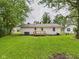 Charming home featuring a wooden deck and a spacious, well-maintained backyard, perfect for outdoor enjoyment and entertainment at 308 Mohawk St, Anderson, IN 46012