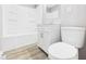 Bright bathroom featuring a shower and tub combo, updated vanity, modern toilet, and neutral decor at 308 Mohawk St, Anderson, IN 46012