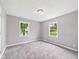 Neutral bedroom features two windows, soft carpet, and light gray walls at 308 Mohawk St, Anderson, IN 46012