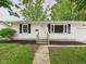 Traditional-style home with black shutters and a neatly landscaped front yard leading to a welcoming front door at 308 Mohawk St, Anderson, IN 46012