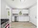 Modern kitchen with stainless steel appliances, white cabinetry, and wood-look flooring at 308 Mohawk St, Anderson, IN 46012