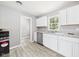 Bright kitchen with modern stainless steel appliances, white cabinets, and durable wood-look flooring at 308 Mohawk St, Anderson, IN 46012