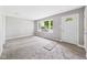 Bright living room with freshly painted grey walls, a new carpet, and a large window at 308 Mohawk St, Anderson, IN 46012