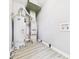 Utility room featuring a water heater, HVAC system, and laminate flooring at 308 Mohawk St, Anderson, IN 46012