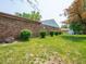 Expansive backyard features a brick house, lush lawn, and storage shed for outdoor enjoyment at 3303 Wedgewood Dr, Indianapolis, IN 46227
