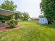Spacious backyard with a blue storage shed and patio, perfect for outdoor activities and storage at 3303 Wedgewood Dr, Indianapolis, IN 46227