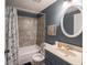 Well-lit bathroom with a tub-shower combo, vanity, and decorative mirror offers a refreshing space at 3303 Wedgewood Dr, Indianapolis, IN 46227