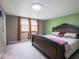 Comfortable bedroom with natural light, plush carpet, and a decorative headboard at 3303 Wedgewood Dr, Indianapolis, IN 46227
