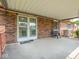 Inviting covered patio with brick exterior, providing ample space for relaxing and entertaining outdoors at 3303 Wedgewood Dr, Indianapolis, IN 46227