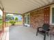 Relaxing covered patio with outdoor seating, offering a serene view of the well-maintained backyard and landscape at 3303 Wedgewood Dr, Indianapolis, IN 46227