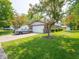 A charming single-story home with a well-maintained lawn, brick accents, and a two-car garage on a sunny day at 3303 Wedgewood Dr, Indianapolis, IN 46227