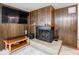 Close-up of the living room fireplace with wood paneling and a mounted TV at 3303 Wedgewood Dr, Indianapolis, IN 46227