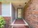 Inviting front entryway with charming welcome sign, brick accents, and a well-lit porch at 3303 Wedgewood Dr, Indianapolis, IN 46227