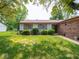 Charming single-story home with well-maintained landscaping and brick accents on a sunny day at 3303 Wedgewood Dr, Indianapolis, IN 46227