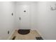 A hallway features neutral walls, flooring, and a white door with a simple doormat and coat hooks at 3303 Wedgewood Dr, Indianapolis, IN 46227