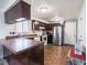 Bright kitchen featuring modern appliances and dark wood cabinets at 3303 Wedgewood Dr, Indianapolis, IN 46227