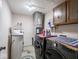 This laundry room features a washer, dryer, water filtration system, and storage cabinets at 3303 Wedgewood Dr, Indianapolis, IN 46227