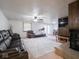 Spacious living room features a brick fireplace, plush leather seating, and a ceiling fan at 3303 Wedgewood Dr, Indianapolis, IN 46227