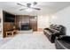 Cozy living room with a fireplace, wood paneling, and a comfortable leather couch at 3303 Wedgewood Dr, Indianapolis, IN 46227