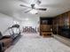 Open-concept living room and dining area with a fireplace and exercise equipment at 3303 Wedgewood Dr, Indianapolis, IN 46227