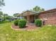 Covered patio with brick accents, offering an outdoor seating area and views of the backyard at 3303 Wedgewood Dr, Indianapolis, IN 46227