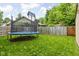 Well-maintained backyard features a trampoline, privacy fence, gazebo, and storage shed, providing endless outdoor fun at 3304 Fox Orchard Cir, Indianapolis, IN 46214