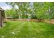 Expansive backyard featuring a wooden fence, playset, fire pit, and storage shed, perfect for outdoor enjoyment at 3304 Fox Orchard Cir, Indianapolis, IN 46214