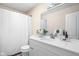 Clean bathroom with a vanity, mirror, sink, toilet, and a shower behind a white curtain at 3304 Fox Orchard Cir, Indianapolis, IN 46214