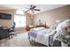 Bedroom featuring a desk, bed with a lilac comforter, a window with blinds, and a ceiling fan at 3304 Fox Orchard Cir, Indianapolis, IN 46214