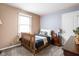 Bedroom with neutral tones, a bed with decorative pillows, a window, and a ceiling fan at 3304 Fox Orchard Cir, Indianapolis, IN 46214