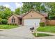 Attractive single-story home featuring a well-kept lawn, brick detailing, and an attached two-car garage at 3304 Fox Orchard Cir, Indianapolis, IN 46214
