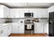 Modern kitchen featuring white cabinets, stainless steel appliances, and stylish backsplash at 3304 Fox Orchard Cir, Indianapolis, IN 46214