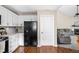 Bright kitchen with white cabinets, dark appliances, and a view into the living area, creating an open feel at 3304 Fox Orchard Cir, Indianapolis, IN 46214