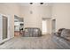 Open-concept living space with a vaulted ceiling, neutral carpeting, and views into the adjacent kitchen at 3304 Fox Orchard Cir, Indianapolis, IN 46214