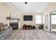 Inviting living room featuring a fireplace, neutral color scheme, and French doors leading to the sunroom at 3304 Fox Orchard Cir, Indianapolis, IN 46214