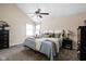 Main bedroom with a ceiling fan, a bed with a patterned comforter, and natural light at 3304 Fox Orchard Cir, Indianapolis, IN 46214