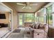 Relaxing sun room with neutral colors, a ceiling fan, and a view of the backyard at 3304 Fox Orchard Cir, Indianapolis, IN 46214