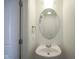 Cozy powder room with a pedestal sink, oval mirror, and neutral decor at 350 N Meridian St # 505, Indianapolis, IN 46204