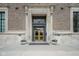 Elegant building entrance with decorative stone surround and symmetrical planter boxes at 350 N Meridian St # 505, Indianapolis, IN 46204